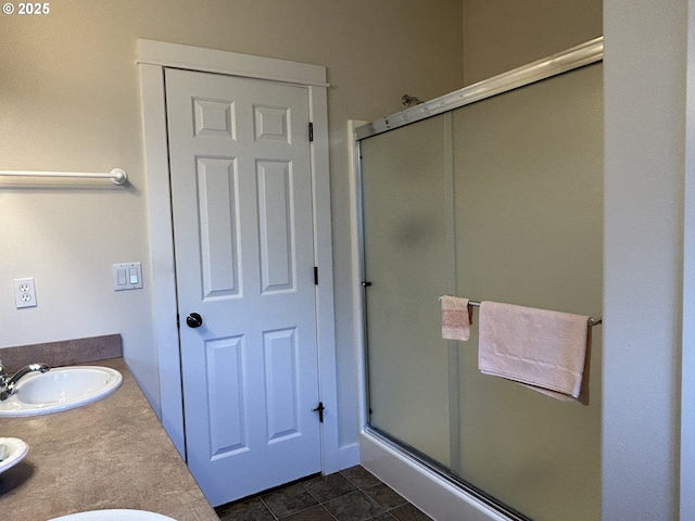 bathroom with tile patterned floors, vanity, and a shower with shower door