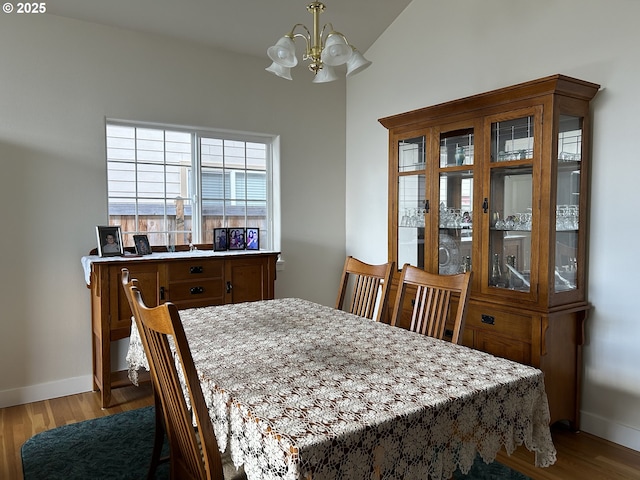 dining area featuring a chandelier and light wood-type flooring