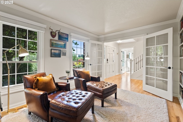 2927 Tolkien Ln, Lake Oswego, OR 97034 - living area featuring french doors, light wood-style floors, ornamental molding, and stairs