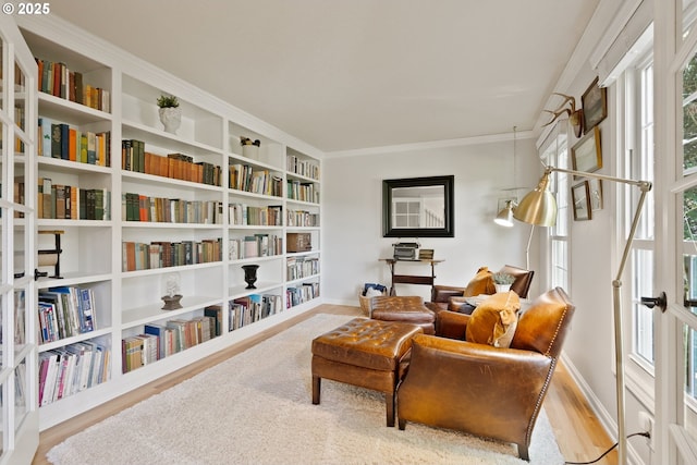 2927 Tolkien Ln, Lake Oswego, OR 97034 - living area with wall of books, wood finished floors, plenty of natural light, and crown molding