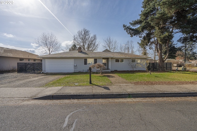 ranch-style house featuring a garage, driveway, a front lawn, and fence