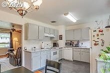 2237 SE 189th Ave, Portland, OR 97233 - kitchen featuring gray cabinetry, light countertops, and a chandelier