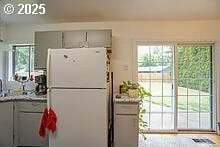 2237 SE 189th Ave, Portland, OR 97233 - kitchen with freestanding refrigerator, gray cabinetry, and plenty of natural light