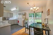 2237 SE 189th Ave, Portland, OR 97233 - dining area featuring a chandelier and dark wood finished floors