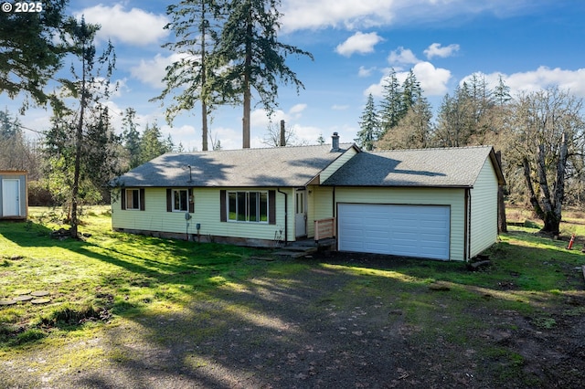 ranch-style home featuring a garage and a front lawn