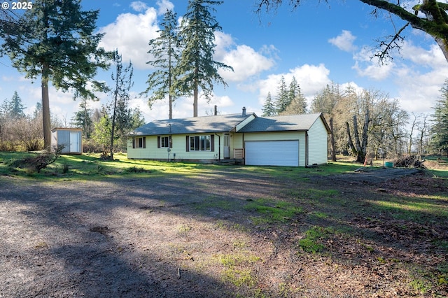 ranch-style house featuring a storage unit and a garage