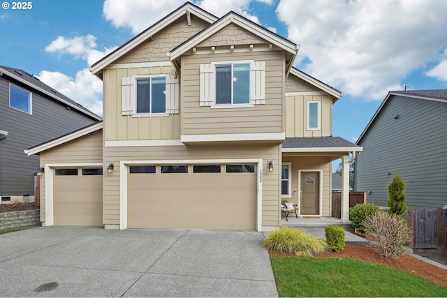 craftsman inspired home with board and batten siding, concrete driveway, a garage, and fence