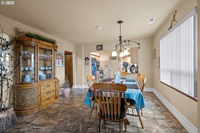 dining space with a chandelier