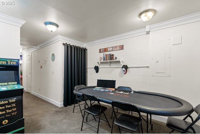 dining room with crown molding and carpet