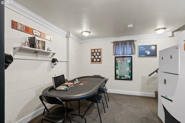 playroom with ornamental molding and dark carpet