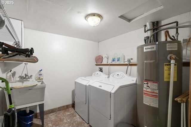 laundry room featuring washing machine and dryer, electric water heater, and light tile patterned flooring