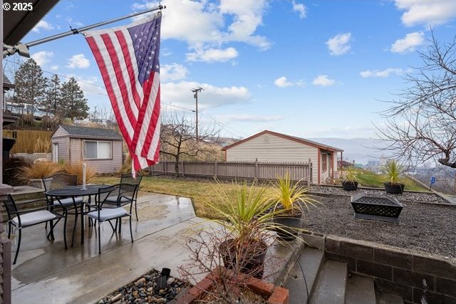 view of patio featuring a storage shed