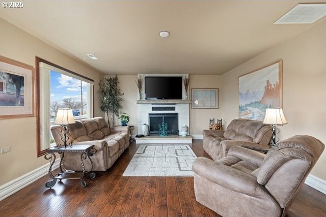 living room featuring a fireplace and dark hardwood / wood-style flooring