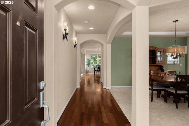 1116 Parkside Ave, Forest Grove, OR 97116 - corridor with arched walkways, a chandelier, wood finished floors, a textured ceiling, and baseboards