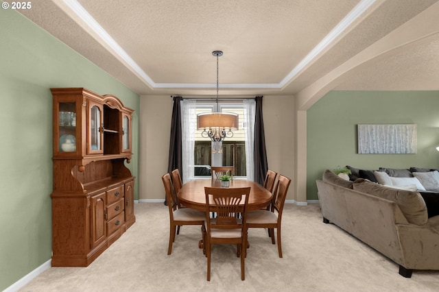 1116 Parkside Ave, Forest Grove, OR 97116 - dining area with a tray ceiling, light carpet, a textured ceiling, baseboards, and arched walkways
