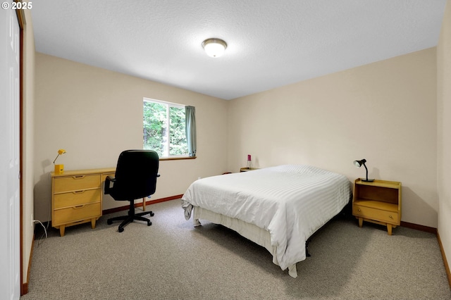 bedroom featuring light colored carpet and baseboards
