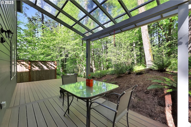wooden terrace with a pergola and outdoor dining space