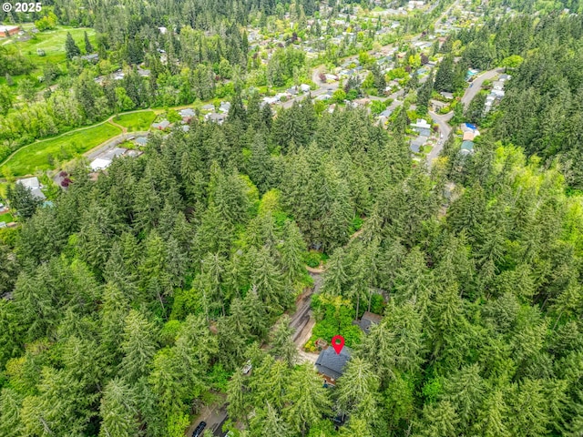 birds eye view of property with a view of trees