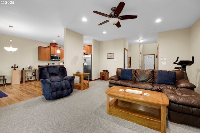 living area featuring a ceiling fan, light colored carpet, and recessed lighting