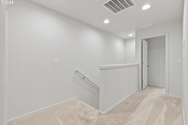 hall featuring recessed lighting, visible vents, baseboards, an upstairs landing, and carpet