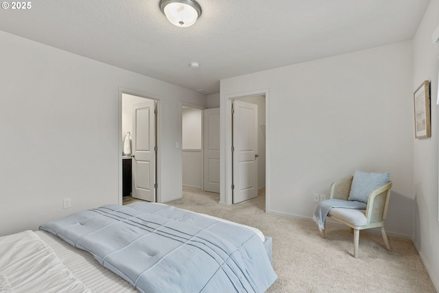 bedroom featuring light carpet, baseboards, and a textured ceiling