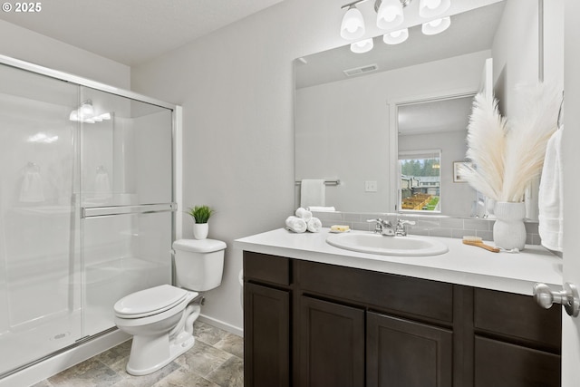 bathroom featuring toilet, a shower stall, visible vents, and vanity