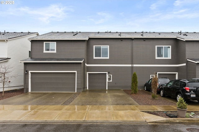 townhome / multi-family property with concrete driveway and an attached garage