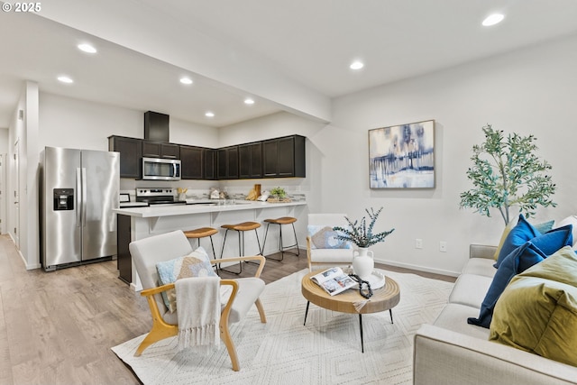 living room with light wood-style floors and recessed lighting