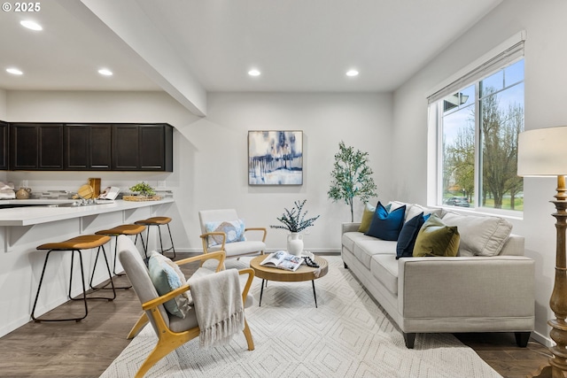 living room with baseboards, light wood-style flooring, and recessed lighting