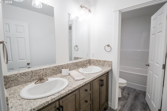 bathroom featuring vanity, toilet, and hardwood / wood-style floors