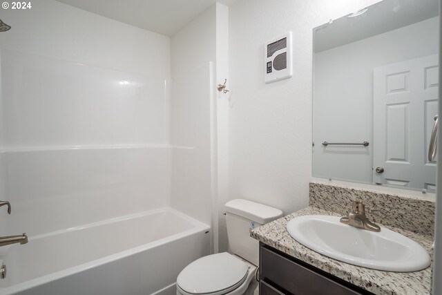 full bathroom featuring vanity, tub / shower combination, and toilet