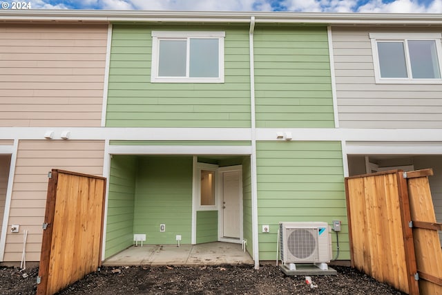 rear view of property featuring ac unit