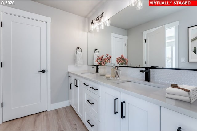 bathroom featuring wood-type flooring and vanity