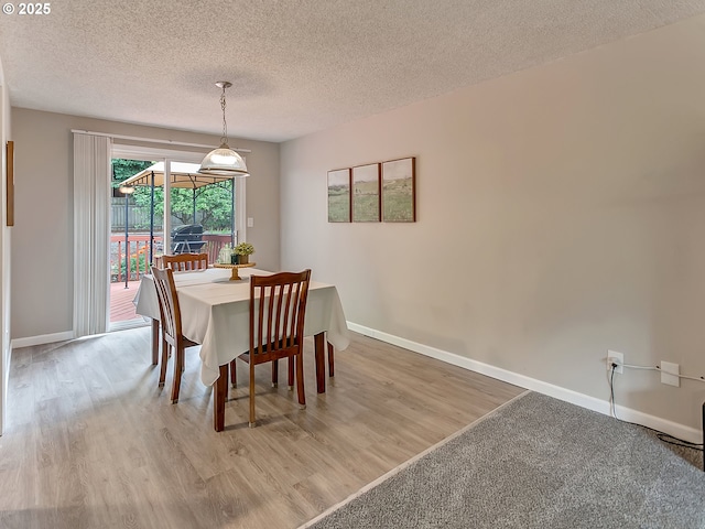 8320 SW Chelan St, Tualatin, OR 97062 - dining area featuring a textured ceiling, baseboards, and light wood-type flooring