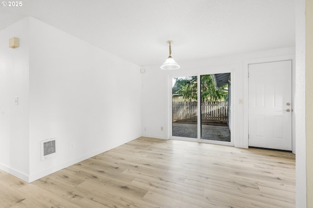 interior space with visible vents, baseboards, and wood finished floors