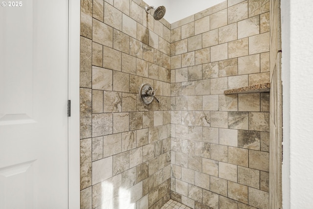 bathroom with a tile shower