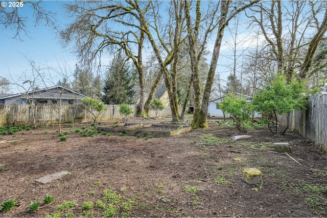 view of yard featuring a garden and a fenced backyard