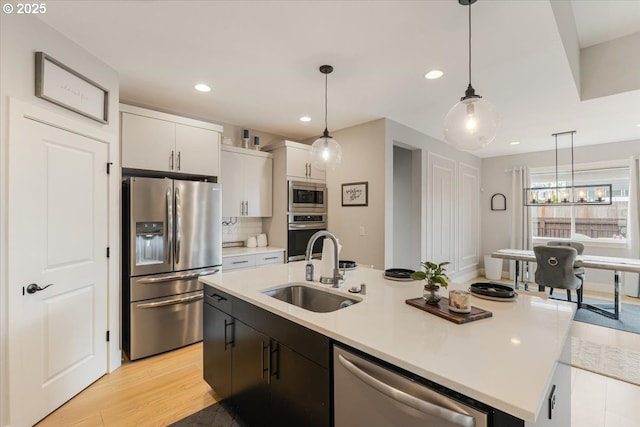 12505 NE 102nd Way, Vancouver, WA 98682 - kitchen featuring appliances with stainless steel finishes, recessed lighting, an island with sink, light countertops, and pendant lighting