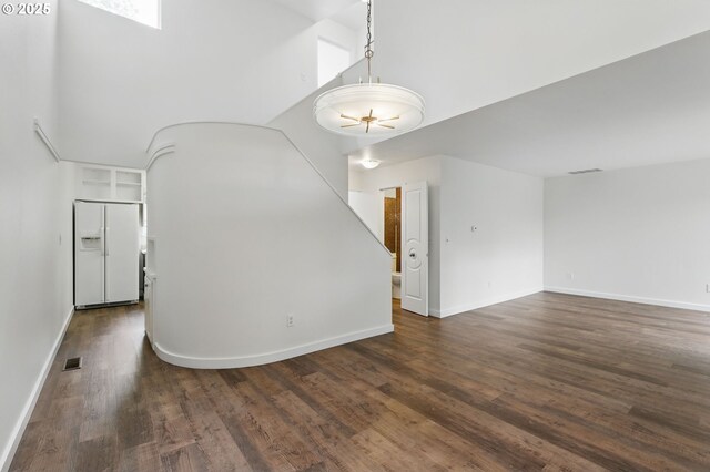 1571 NW Tanasbrook Ct, Beaverton, OR 97006 - spare room with dark wood-type flooring, baseboards, and a towering ceiling