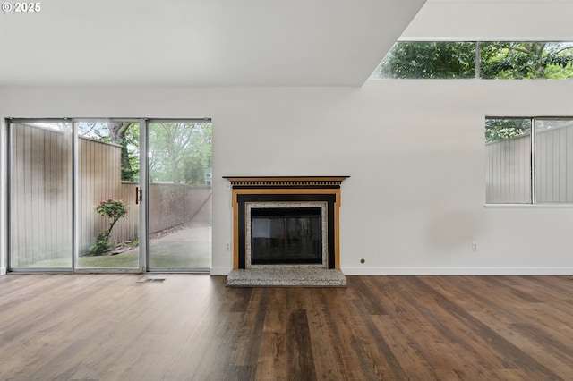 1571 NW Tanasbrook Ct, Beaverton, OR 97006 - unfurnished living room with wood finished floors, baseboards, healthy amount of natural light, and a glass covered fireplace