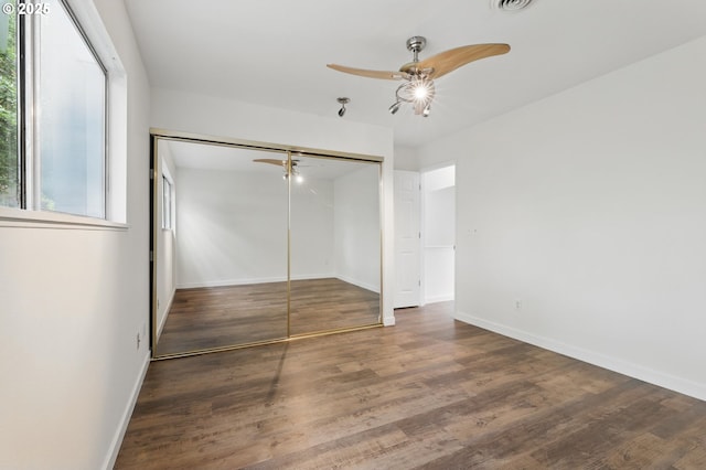 1571 NW Tanasbrook Ct, Beaverton, OR 97006 - unfurnished bedroom with wood finished floors, a closet, baseboards, and ceiling fan