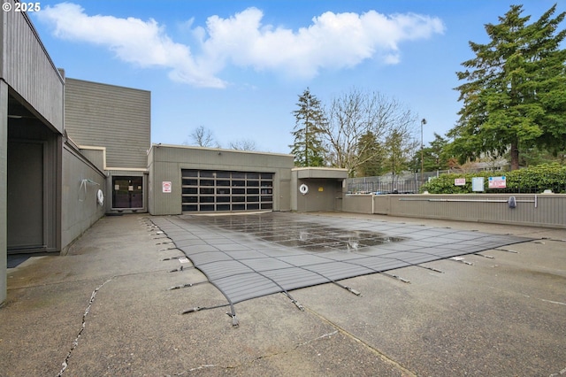 1571 NW Tanasbrook Ct, Beaverton, OR 97006 - view of patio / terrace featuring an attached garage, concrete driveway, and fence