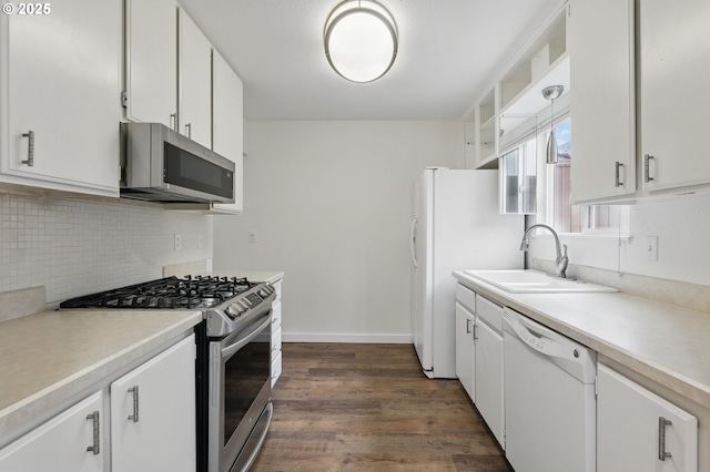1571 NW Tanasbrook Ct, Beaverton, OR 97006 - kitchen featuring appliances with stainless steel finishes, a sink, decorative backsplash, light countertops, and dark wood-type flooring