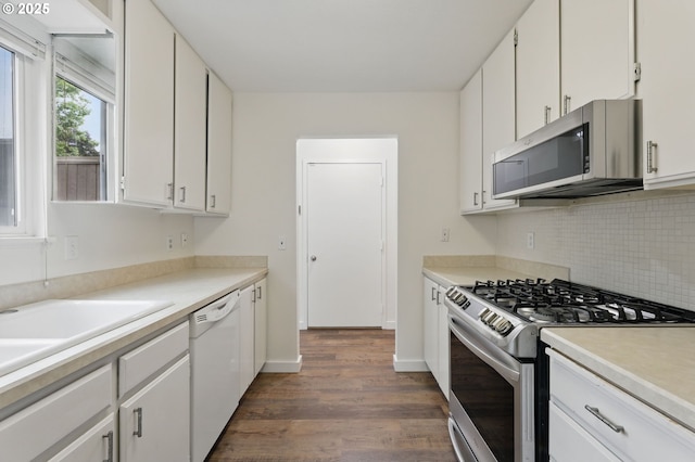 1571 NW Tanasbrook Ct, Beaverton, OR 97006 - kitchen with stainless steel appliances, dark wood-type flooring, backsplash, and white cabinets