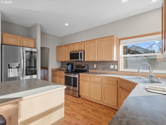 kitchen featuring stainless steel appliances, tasteful backsplash, sink, and light brown cabinets