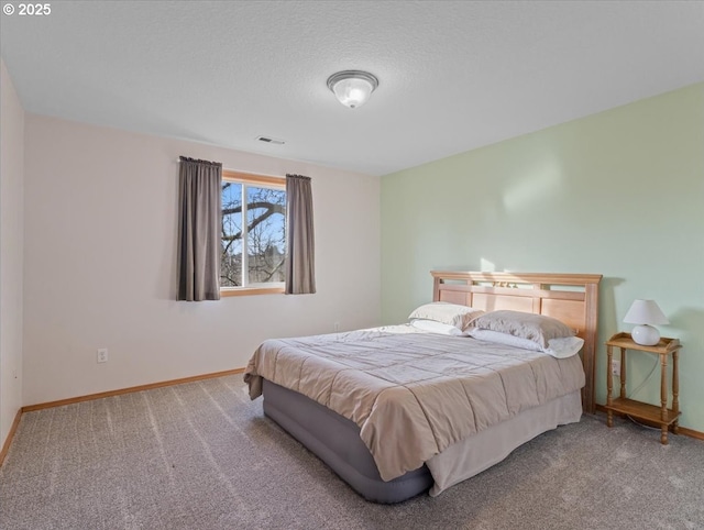 carpeted bedroom with a textured ceiling