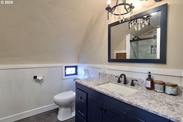 789 W Main St, Carlton, OR 97111 - bathroom featuring toilet, vanity, a stall shower, a wainscoted wall, and lofted ceiling