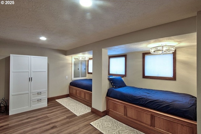 789 W Main St, Carlton, OR 97111 - bedroom featuring a textured ceiling, a chandelier, wood finished floors, baseboards, and recessed lighting