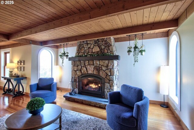 789 W Main St, Carlton, OR 97111 - living area with baseboards, wood ceiling with exposed beams, wood finished floors, and a stone fireplace