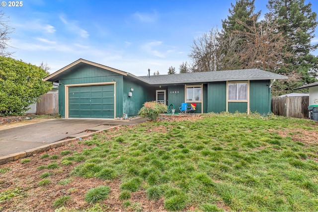 single story home with a garage, fence, concrete driveway, and a front yard